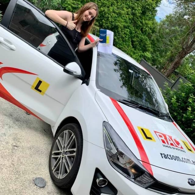 Learner beside a white RAC learner car