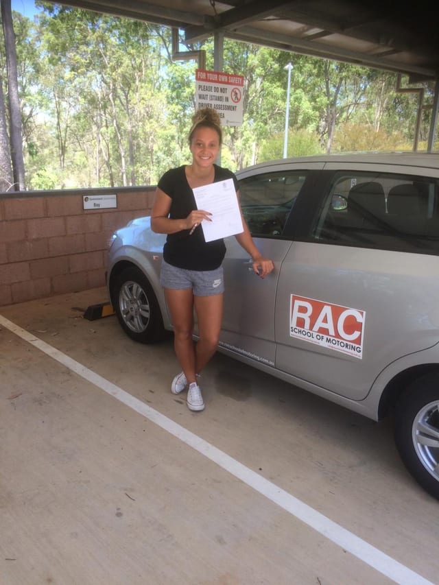 Learner beside a silver RAC driving-school car